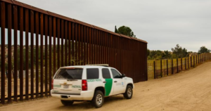 border-patrol-driving-near-wall-800x420