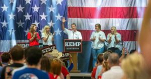 brian kemp in front of flag