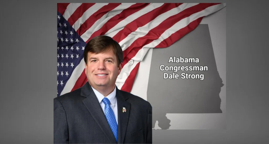 Alabama congressman Dale Strong with a picture of the American flag in the background and a map of alabama